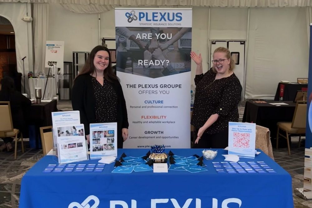 Plexus associates at the Marriott Lincolnshire career fair with a banner and marketing materials.